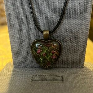 Black leather necklace with pink flower pendant